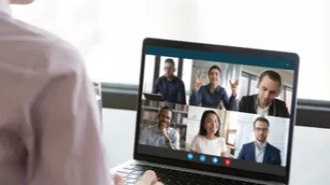 Persona participando en una videollamada grupal desde una laptop.