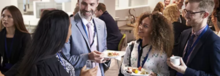 Grupo de profesionales conversando en una conferencia.